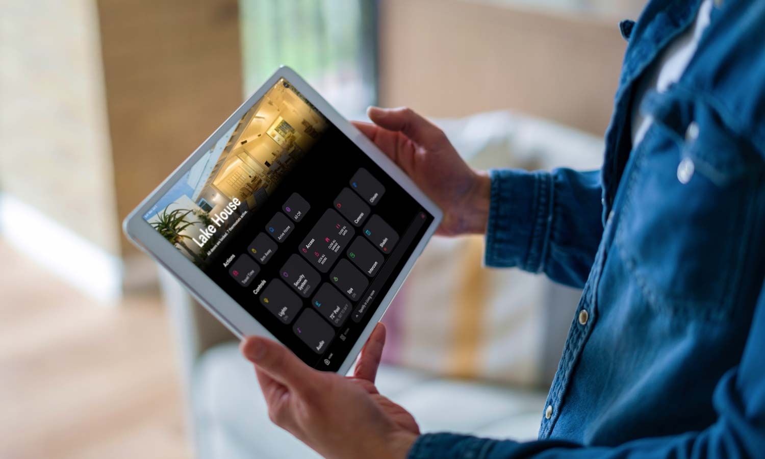 Crestron Touch panel in a able with a traditional home in the background